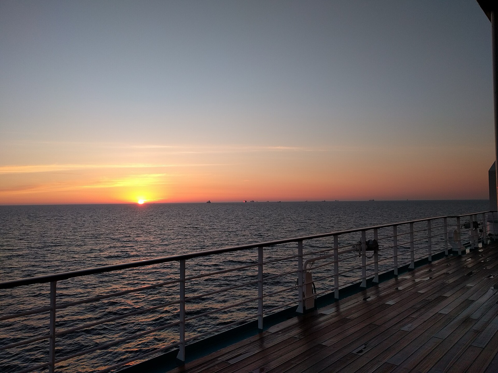 Cruise ship deck view at sunset over the ocean